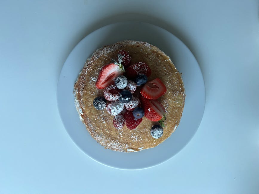 Nederlandsk baby-pannekake med bringebær- og appelsincoulis